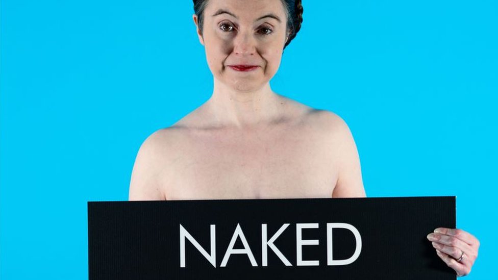 Victoria Bateman holding a banner which reads naked