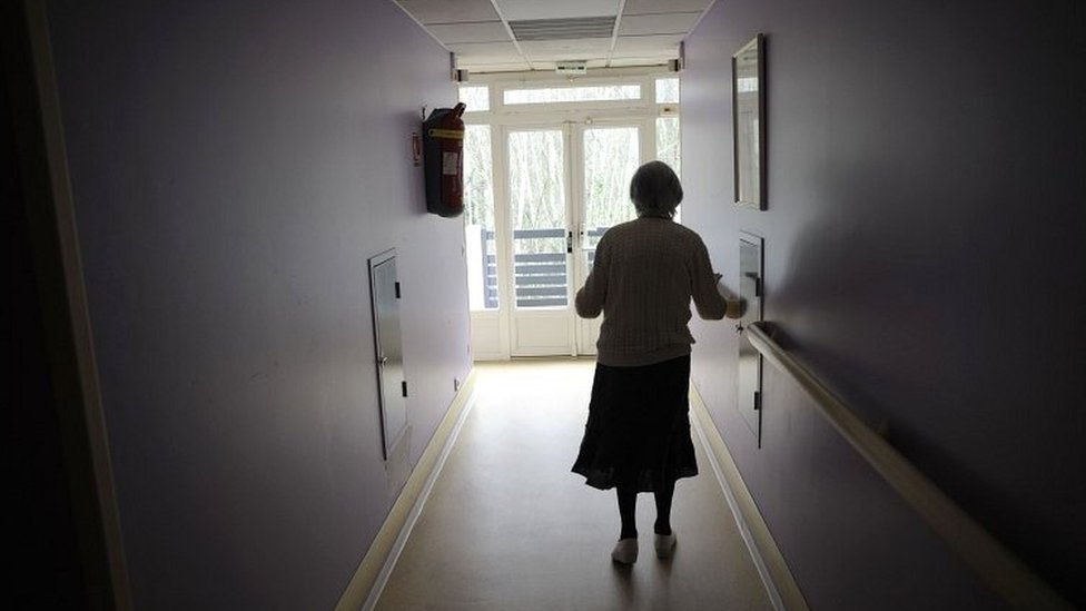 A woman, suffering from Alzheimer's disease walks in a corridor in a retirement house in Angervilliers, eastern France (2011 file picture)