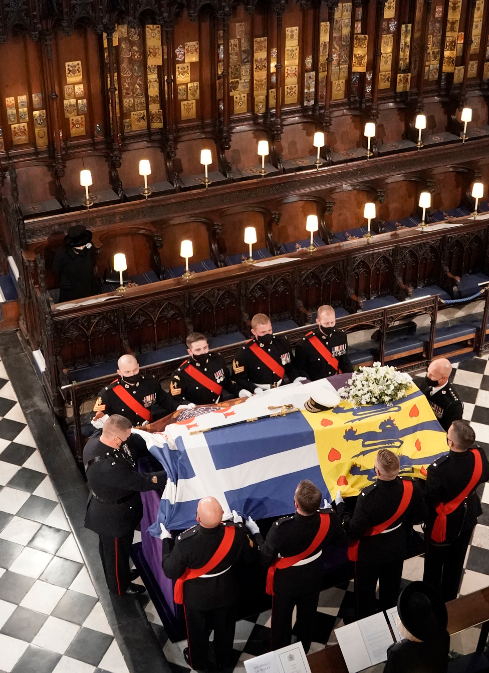 Queen Elizabeth II watches as the coffin of the Duke of Edinburgh is placed St George"s Chapel, Windsor Castle, Berkshire during his funeral service.