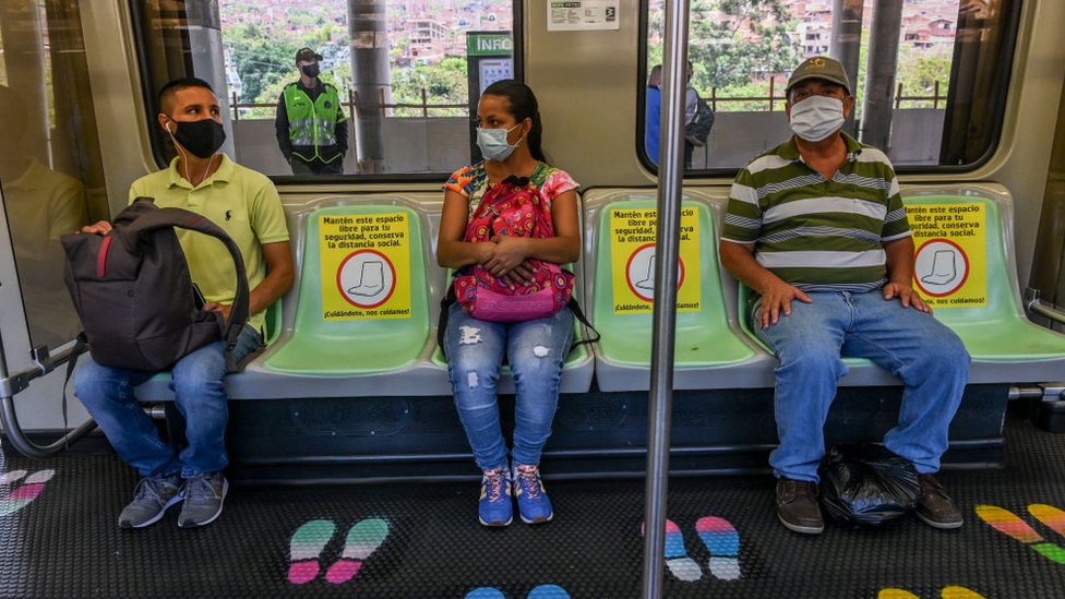 Personas usando mascarillas en el metro de Medellín.
