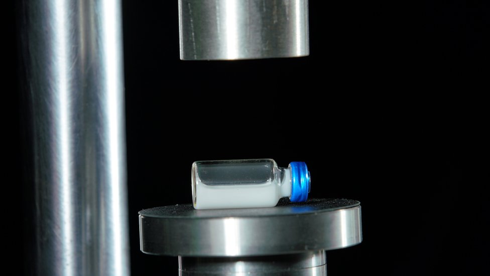 Glass vial under press