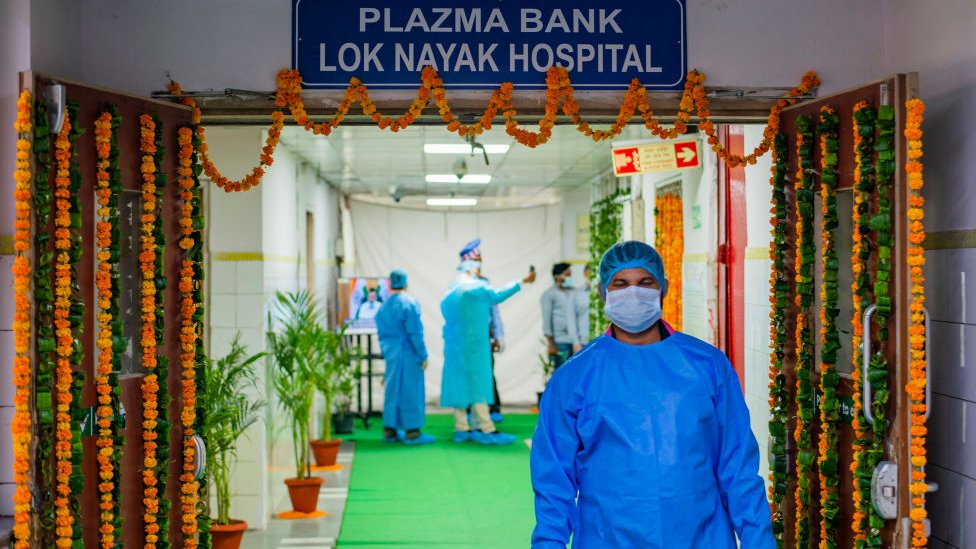 A technician wearing a personal protective Equipment suit (PPE) is seen coming from the Plasma Bank. Delhi's second plasma bank started today. Delhi has the highest Covid-19 recovery rate within the whole of India