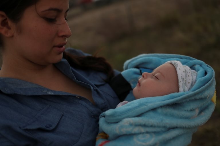 Una mujer guatemalteca sostiene a su bebé después de cruzar la frontera a Estados Unidos.