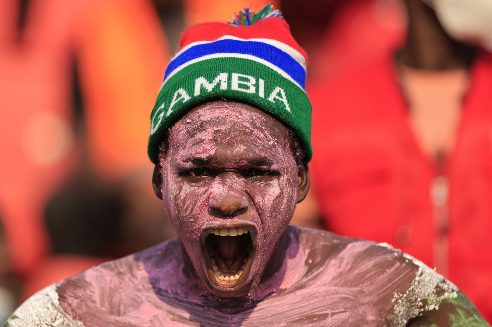 مشجع من غامبيا لا يصدق نفسه بعد تأهل منتخب بلاده إثر الفوز على منتخب غينيا، يوم الإثنين