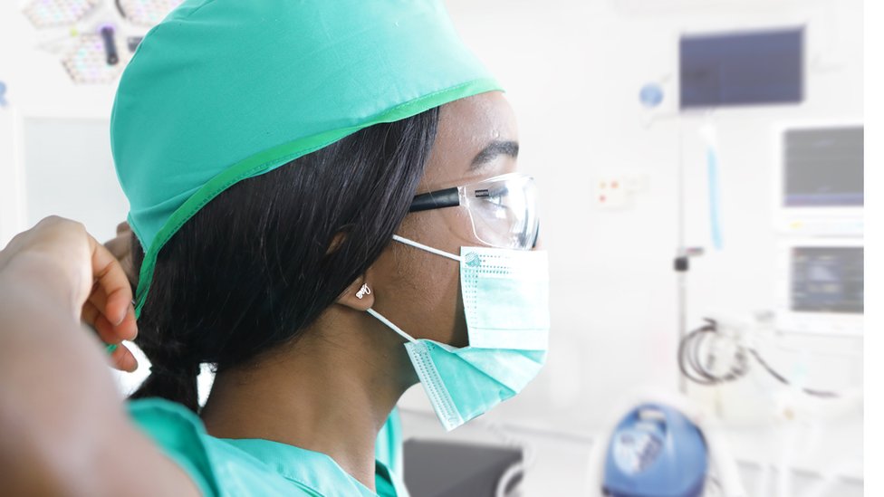 nurse putting on a mask