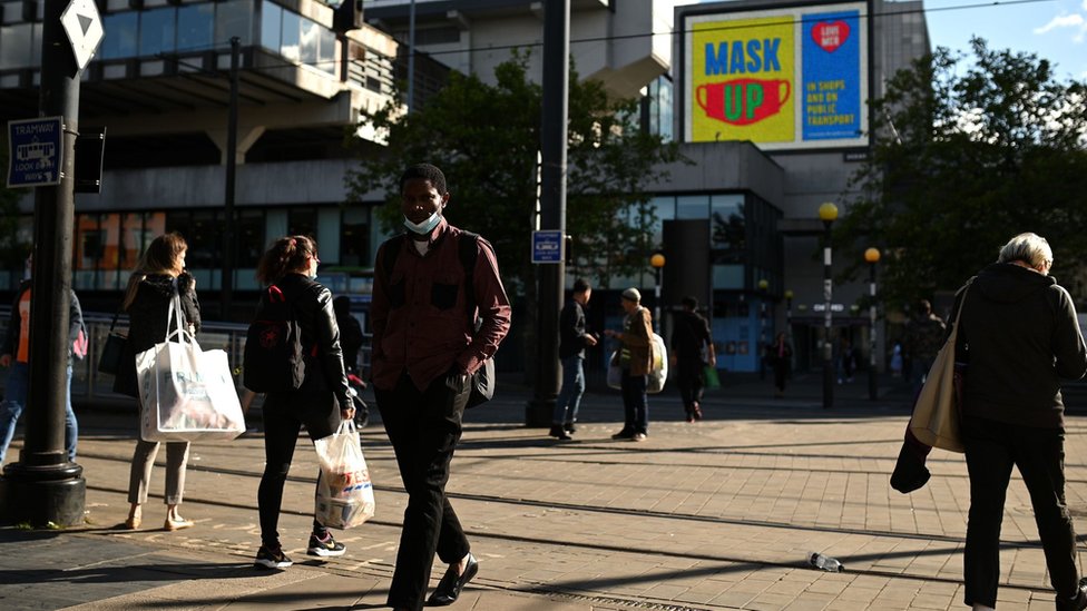 A person wears a mask in Manchester City Centre