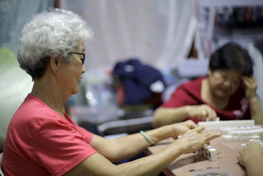 Women playing the Chinese game of mahjong