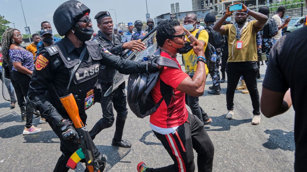 A policeman arresting a protestor during a demonstration against the re-opening of the Lekki toll plaza in Lagos.