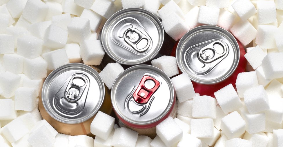 Cans of sugary soft drinks