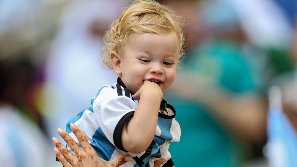 A boy in the Argentina shirt during the match against Saudi Arabia.