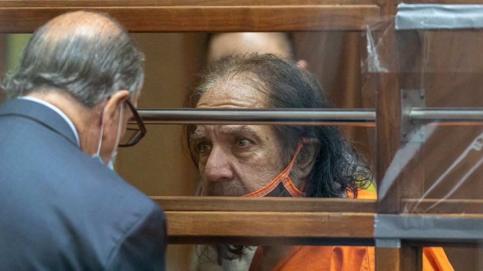 Ron Jeremy speaks to his lawyer while in court in 2020