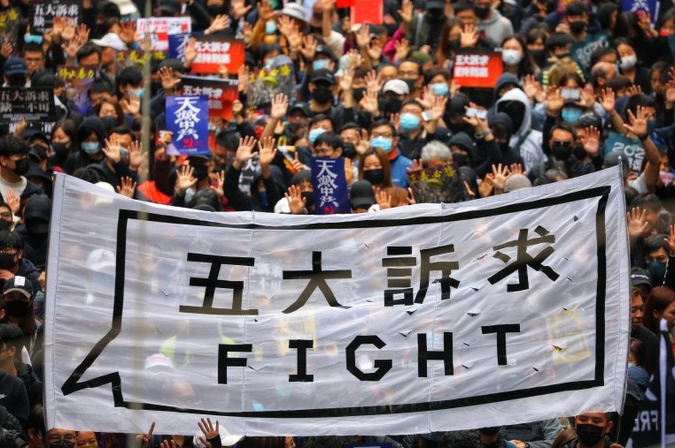People hold a banner reading "Fight" as they take part in an anti-government rally on New Year's Day in Hong Kong