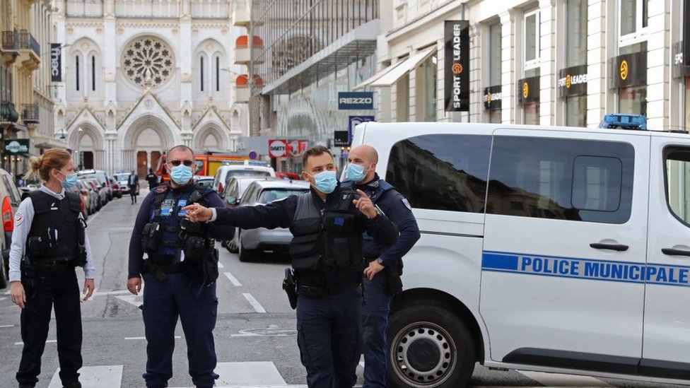 French policemen stand guard the street leading to the Basilica of Notre-Dame de Nice