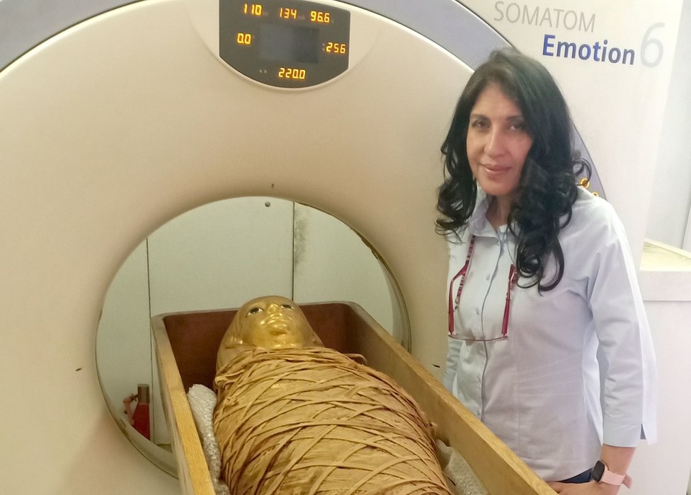 Dr Sahar Saleem, professor of radiology at Cairo University's Kasr Al-Ainy Faculty of Medicine, stands next to the mummy of Amenhotep I and a CT scanner