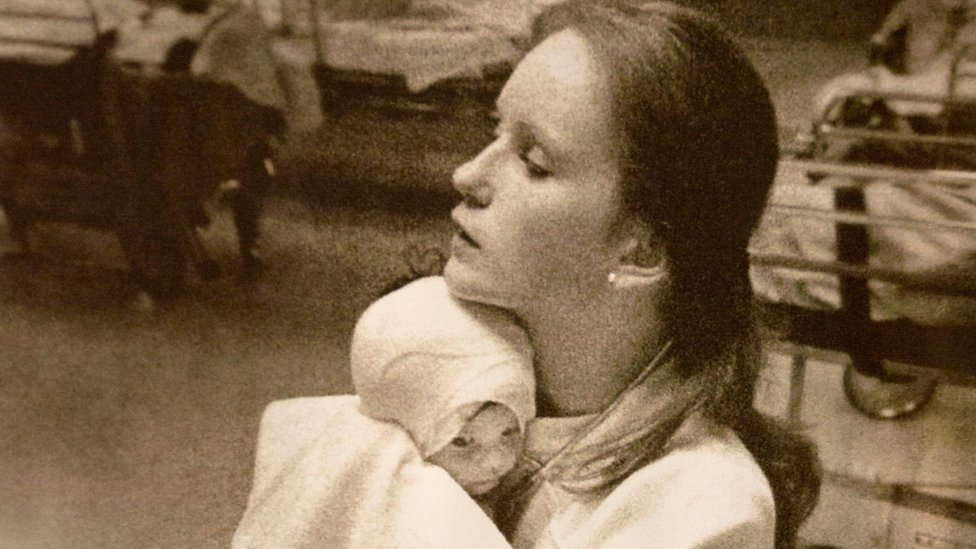 Susan Berger cuddles infant Amanda Scarpinati in 1977