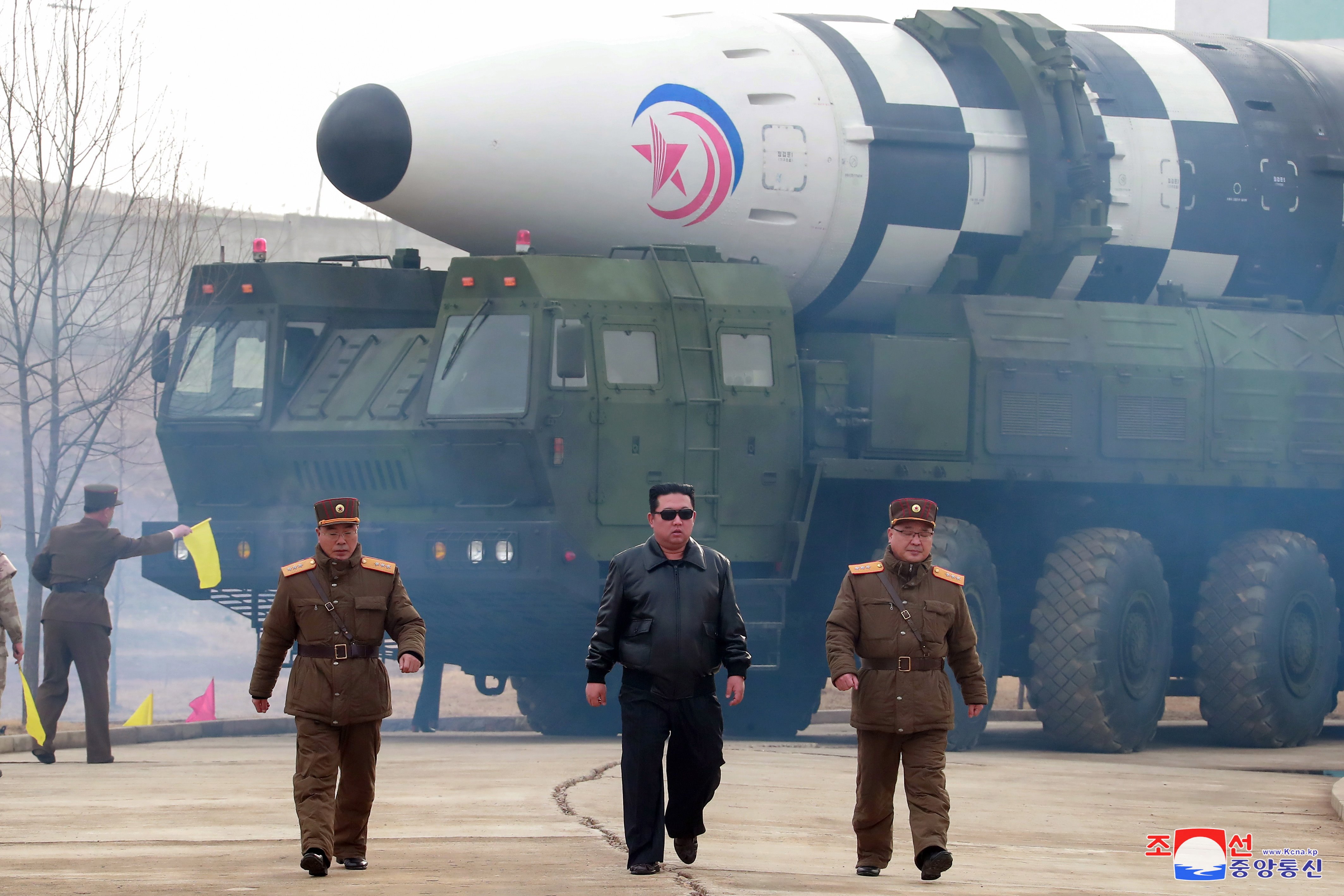 Photo released by the official North Korean Central News Agency (KCNA) shows Kim Jong Un (C), Jang Chang-ha (L rear), Chief of the Academy of National Defense, and Kim Jong-sik (R), the Deputy Director of the Munitions Industry Department, during the test-launch of a new type of inter-continental ballistic missile Hwasongpho-17 of the DPRK strategic forces that was conducted on 24 March 2022