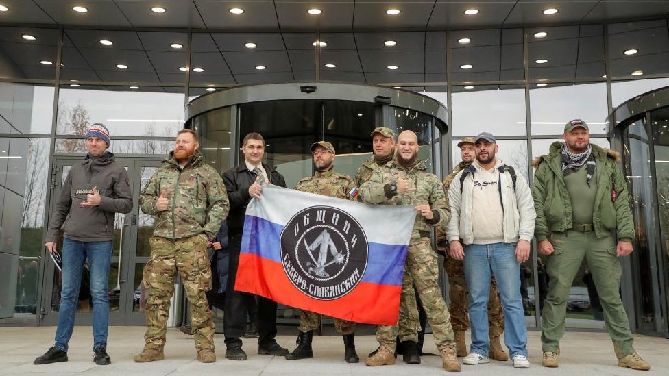 Members of Wagner Group and visitors stand outside new headquarters in St Petersburg