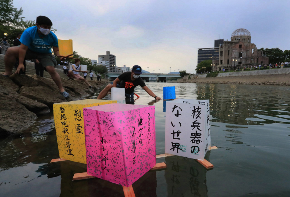 People float paper lanterns on water in Hiroshima