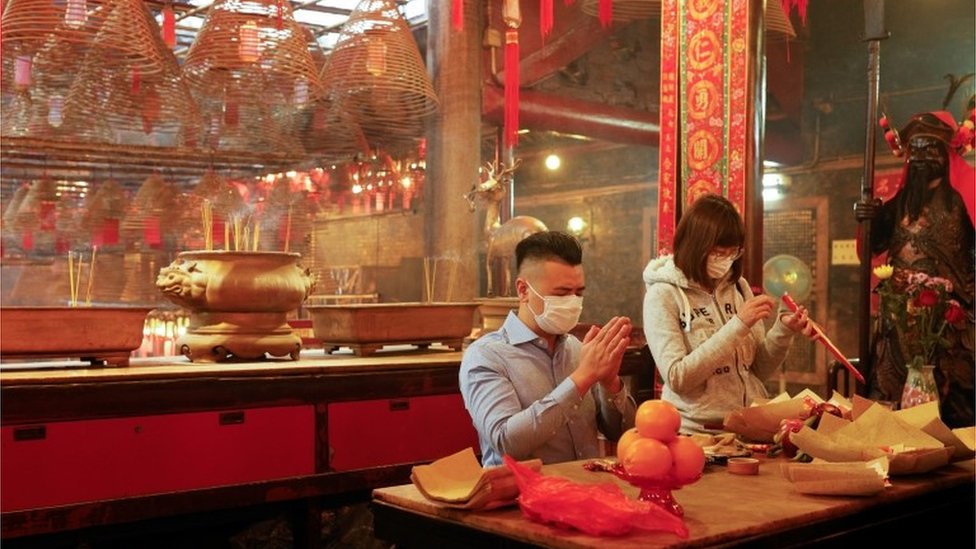Worshippers, wearing face mask, pray ahead of the Chinese Lunar New Year, following the coronavirus disease (COVID-19) outbreak, at Man Mo Temple, in Hong Kong, China February 11, 2021.