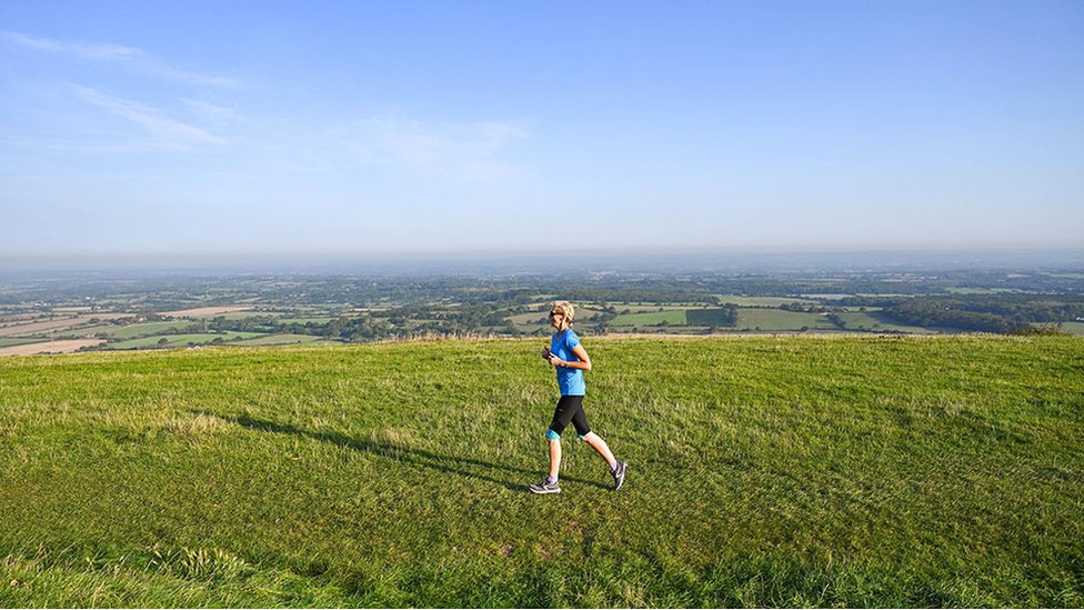 A runner enjoys the sunshine on Devils Dyke just north of Brighton