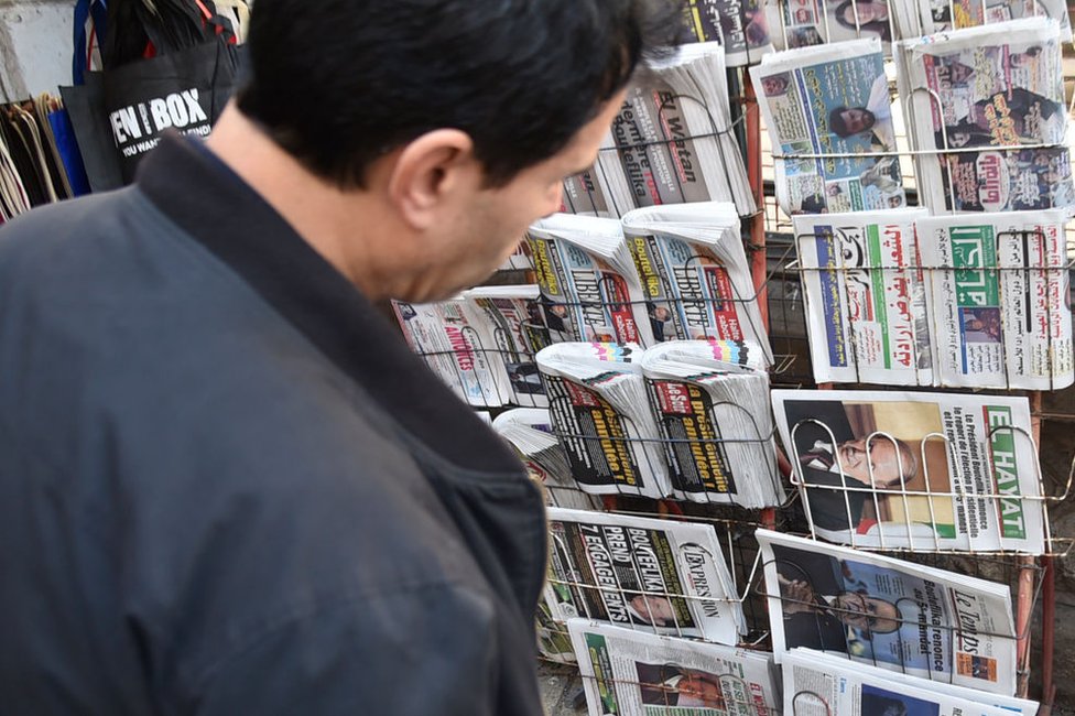 A man looks at newspaper front page on the day in March 2019 when then-President Abdelaziz Bouteflika announced he was no longer seeking a fifth term in office.