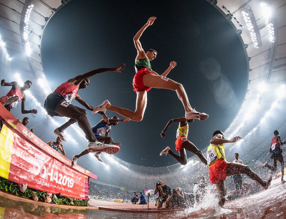 Leonard Kipkemoi Bett of Kenia and Soufiane El Bakkali of Morocco clear the water jump as they compete in the Men's 3000 metres Steeplechase final during day eight of 17th IAAF World Athletics Championships Doha 2019 at Khalifa International Stadium on October 04, 2019 in Doha, Qatar.