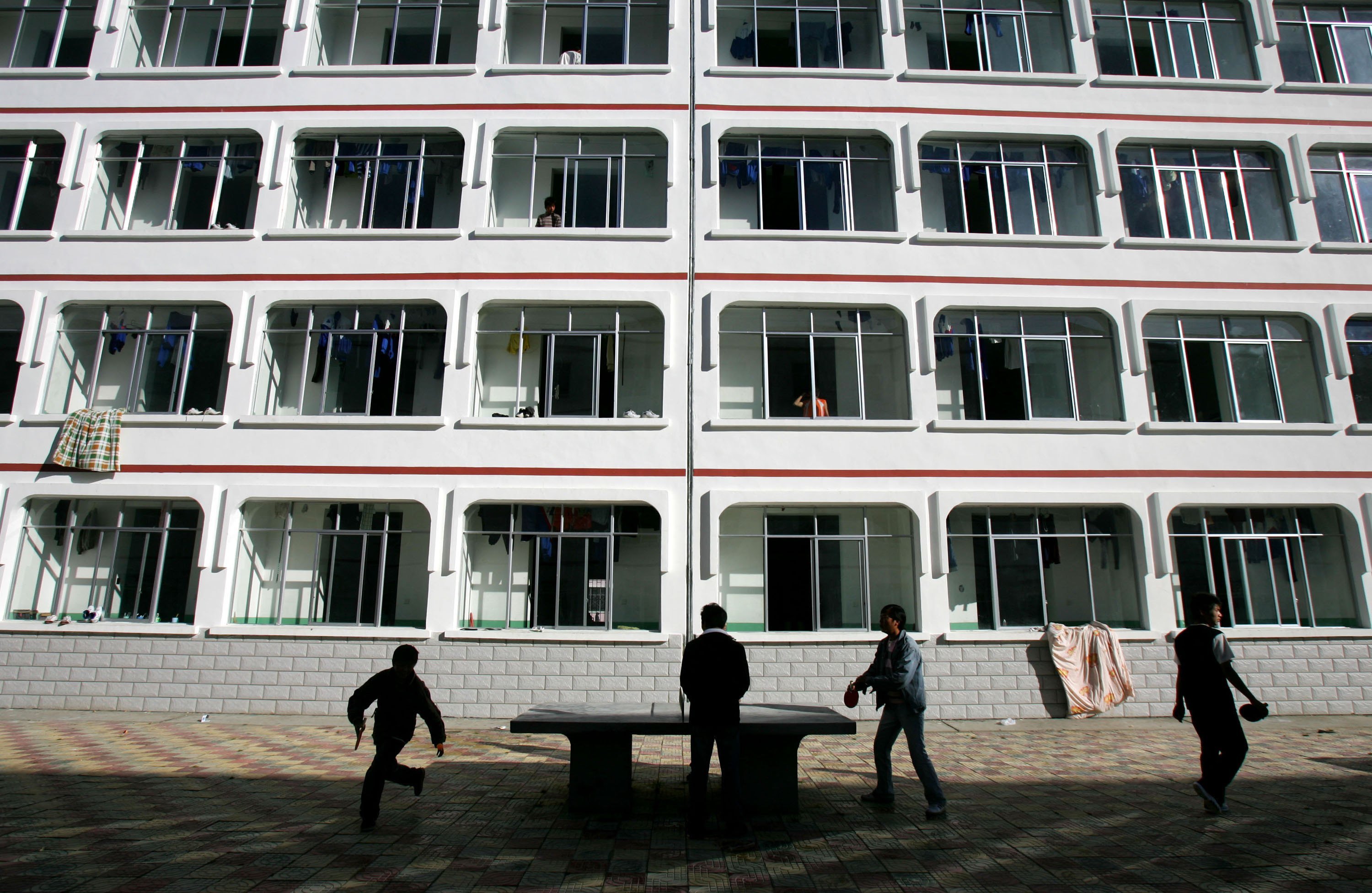 Tibetan students play table tennis in front of a dormitory at Nyingchi First High School, the only high school of Nyingchi Prefecture, on October 29, 2006 in Nyingchi County of Tibet Autonomous Region, China.