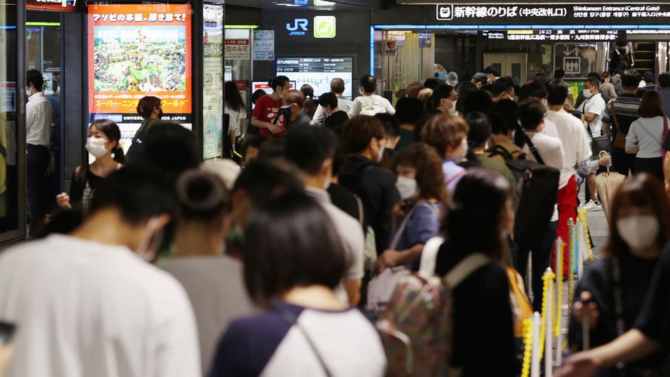 Passengers gather as train service is suspended due to Typhoon Nanmadol approaching Kyushu region, at Hakata station of Fukuoka on September 18, 2022.