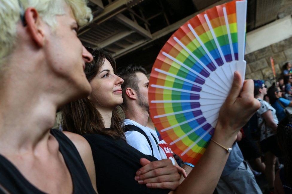 A participant holds a fan with rainbow colours during the lesbian, gay, bisexual and transgender (LGBT) Pride Parade in Budapest on July 24, 2021.