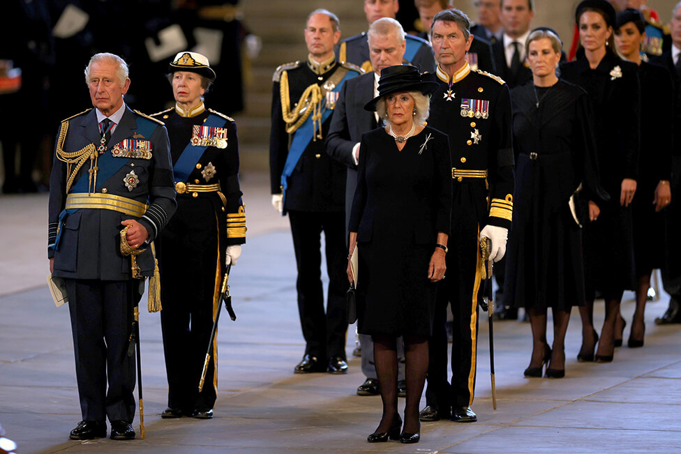 King Charles III and the Queen Consort leading a line of member of the Royal Family