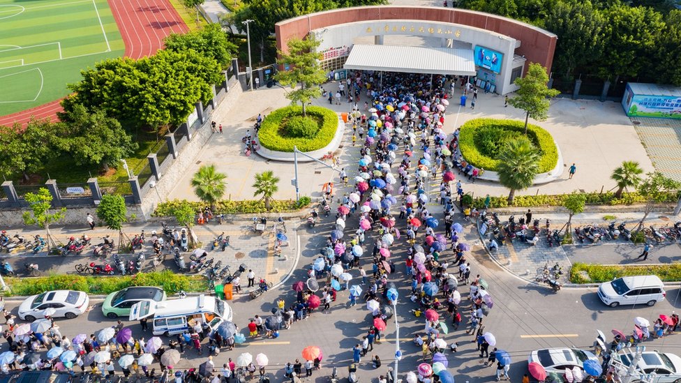 Aerial view of local residents queue up for COVID-19 nucleic acid testing at a primary school on September 14, 2021 in Xiamen, Fujian Province of China