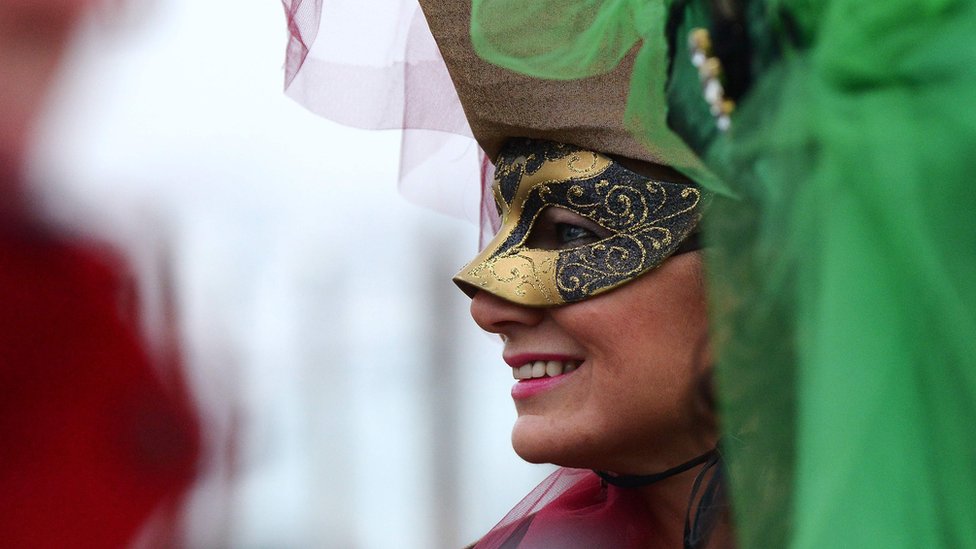 A costumed reveller smiles at St Mark's Square (Piazza San Marco) during the Venice Carnival 30 January 2016.