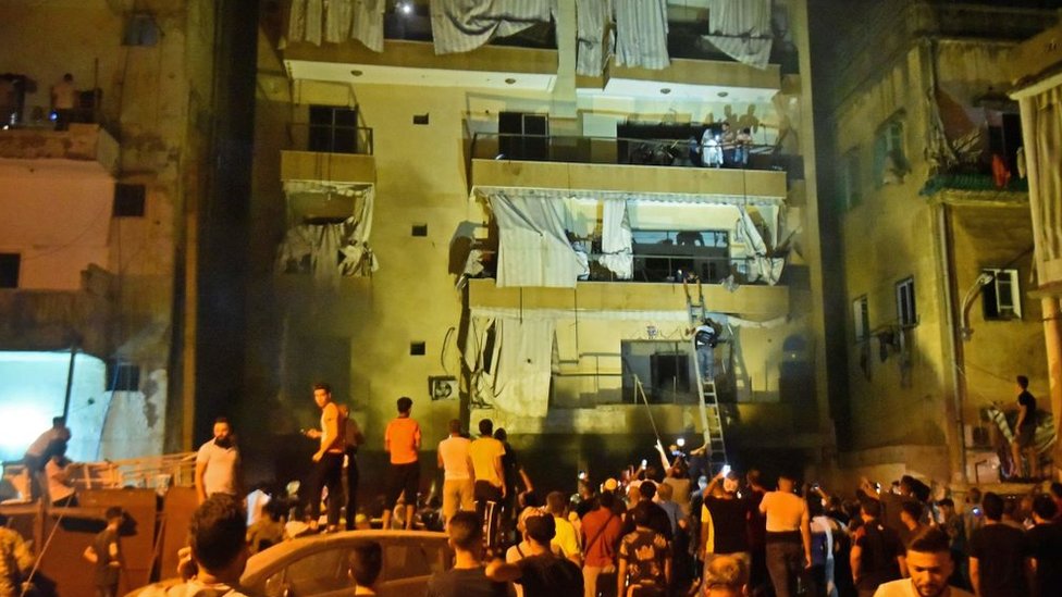 Rescuers evacuate residents after an explosion in the Tariq al-Jdide district of Lebanese capital Beirut