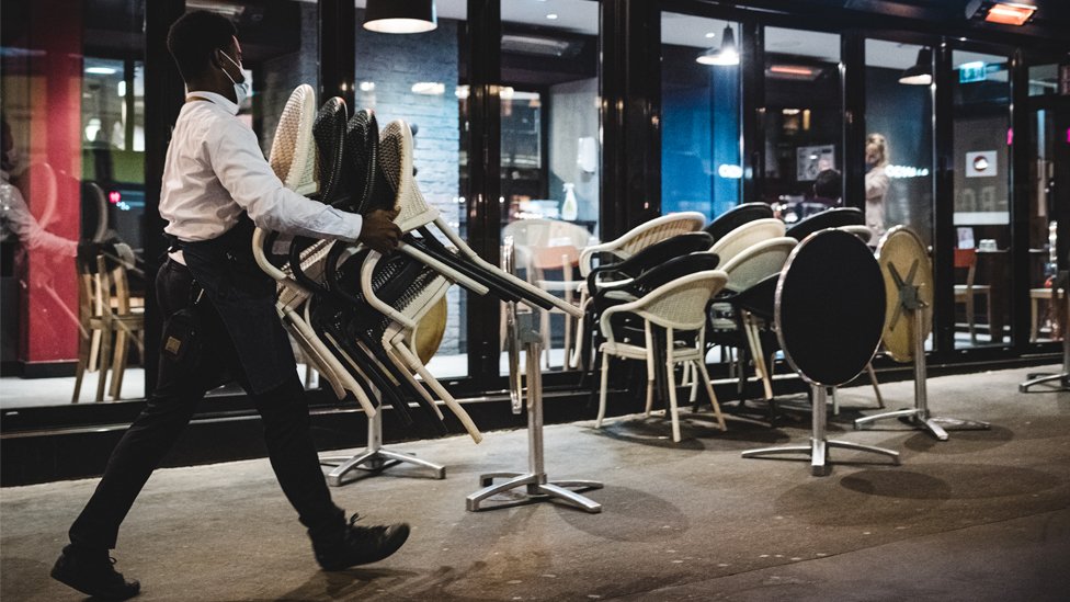 Man carrying chairs in Paris