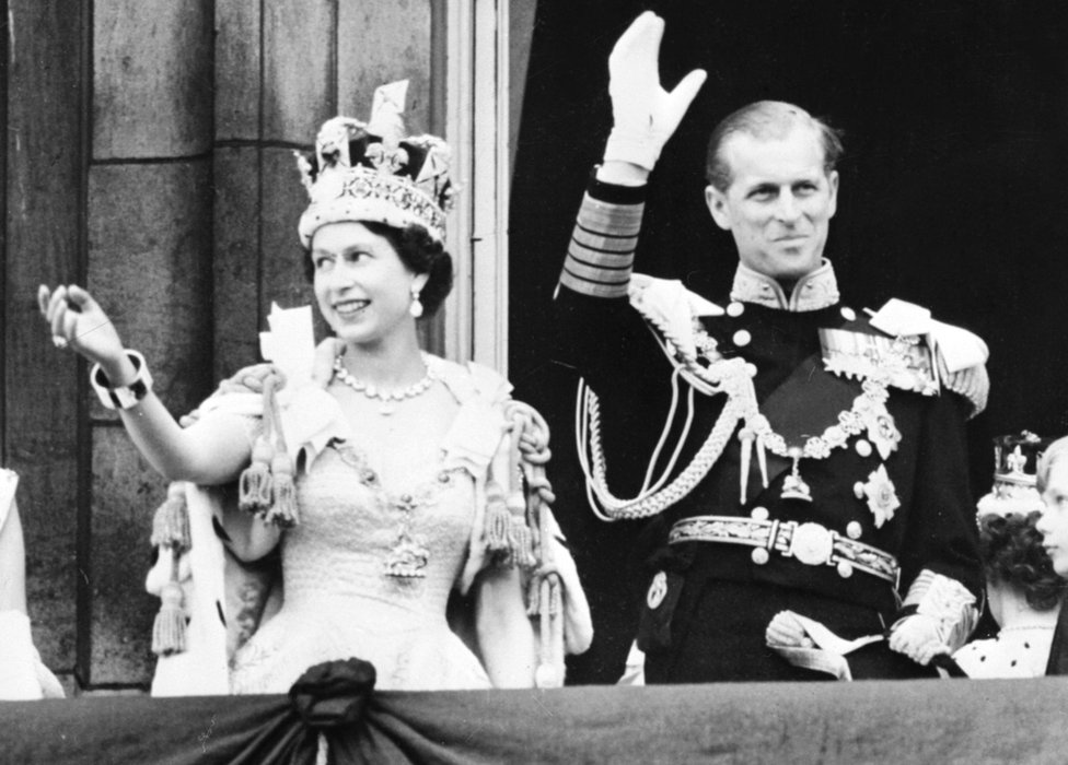 Queen Elizabeth II accompanied by Prince Philip waves to the crowd, 02 June 1953