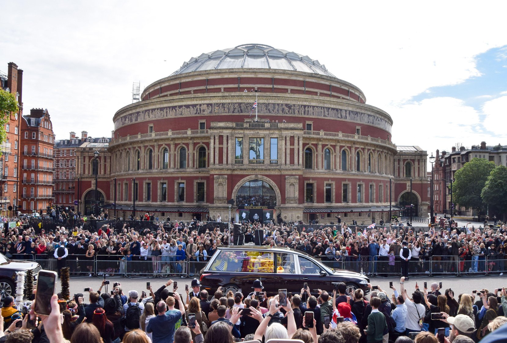 The hearse passes crowds gathered outside the Royal Albert Hall