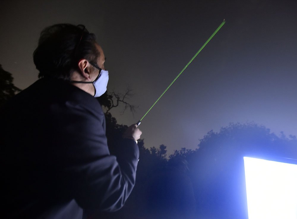 A man uses a laser pointer