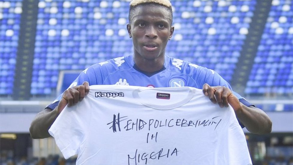 Napoli"s forward Victor Osimhen shows a shirt reading "End police brutality in Nigeria" as he celebrates after scoring a goal during the Italian Serie A soccer match SSC Napoli vs Atalanta BC at the San Paolo stadium in Naples, Italy, 17 october 2020.