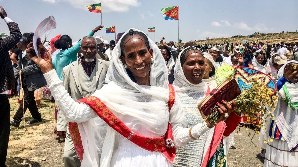 Women waving and smiling