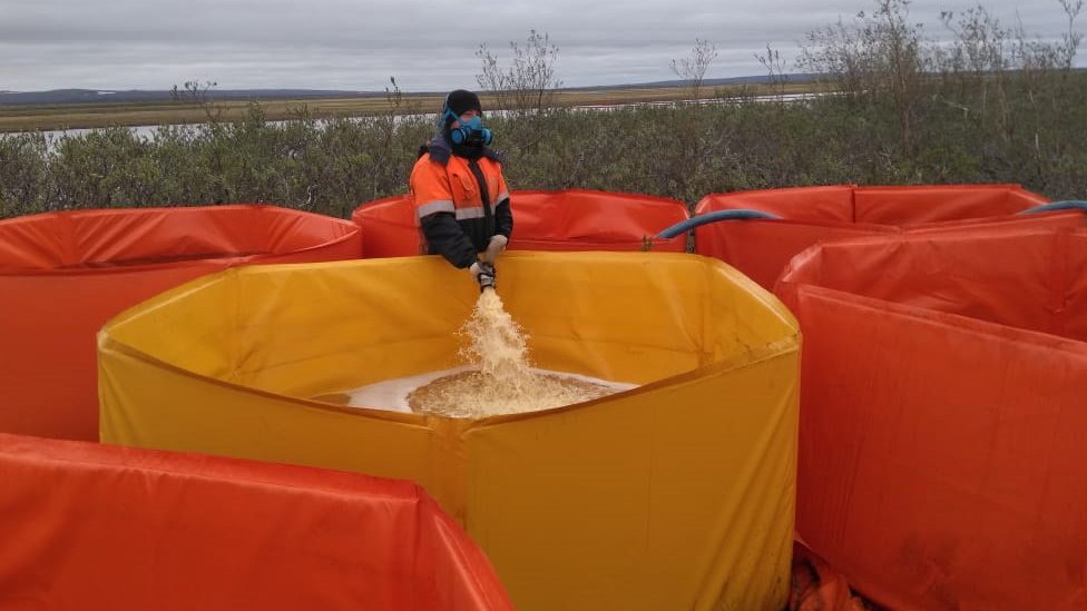 Polluted water being pumped into portable containers