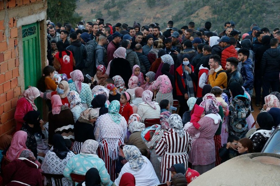 People gather close tot he rescue site on 3 February.
