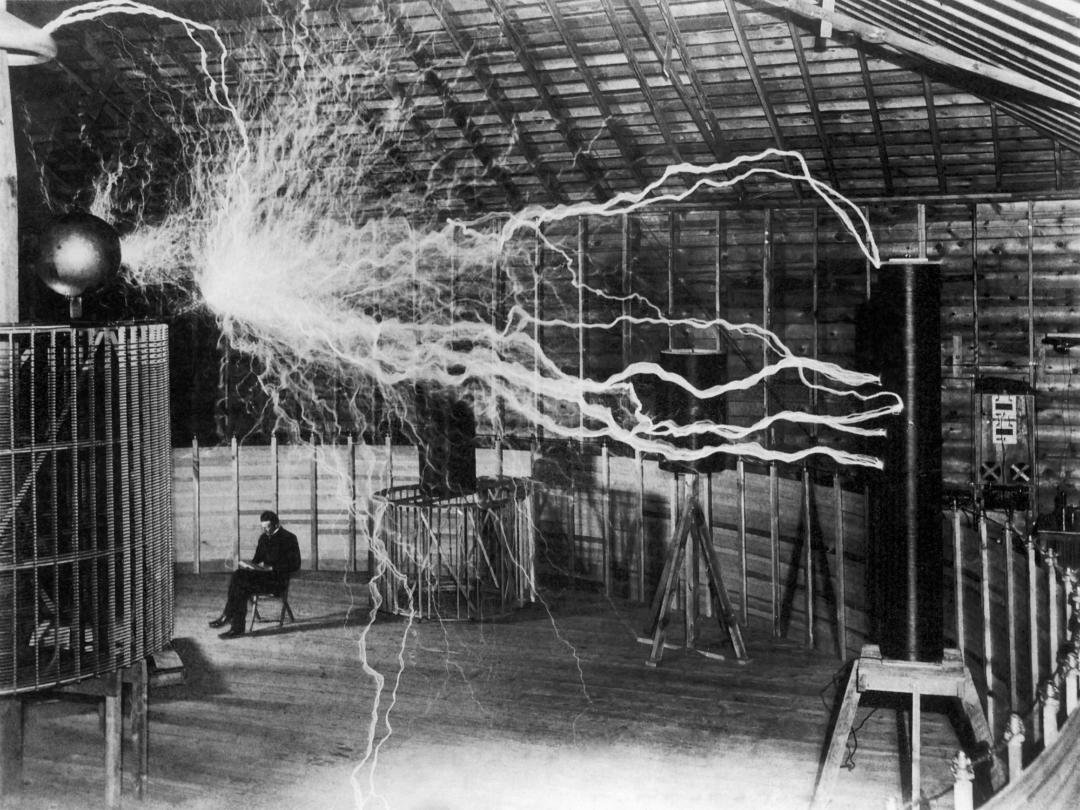 In December 1899, Tesla took a photo with the "magnifying transmitter" in his laboratory