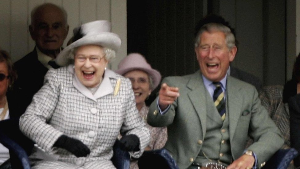 Prince Charles, The Prince of Wales, pointing and laughing with his mother the Queen as they watch competitors during the Braemar Gathering at the Princess Royal and Duke of Fife Memorial Park on September 2, 2006 in Braemar, Scotland.