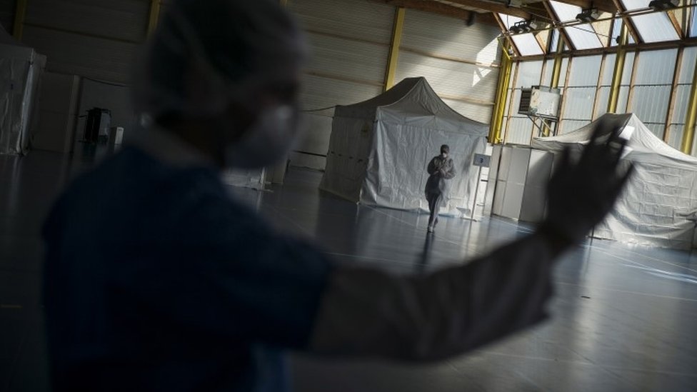 A health care worker waits in an emergency centre in France