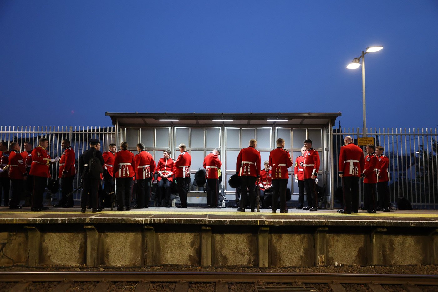 Members of the Armed Forces wait for a train in the early hours of Saturday morning