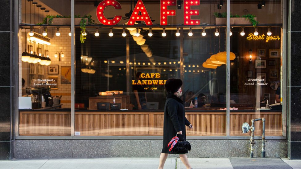 A woman in a mask walks through downtown Toronto, 7 October, 2020