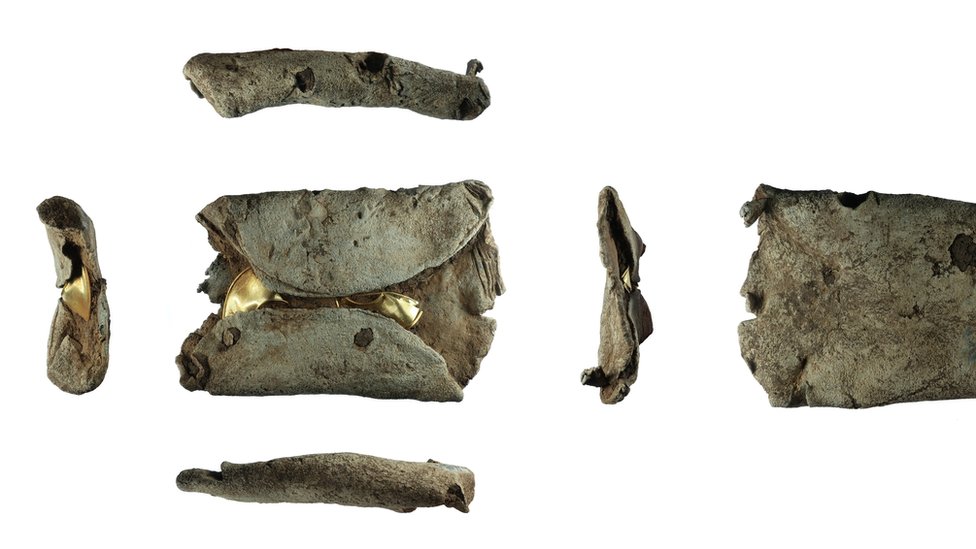 Два золотых замковых кольца позднего бронзового века внутри свинцового слитка, который был повторно использован в качестве грузила