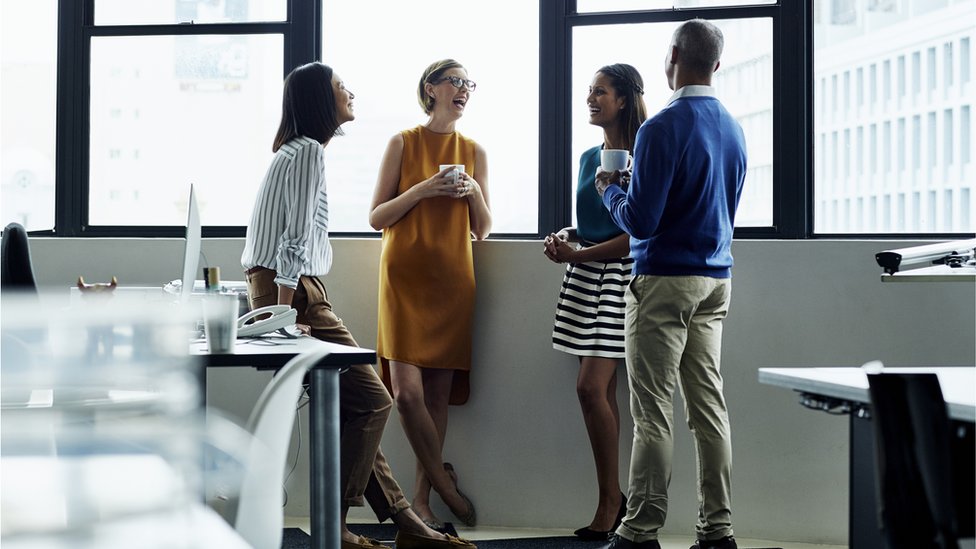 The employees are talking in the office