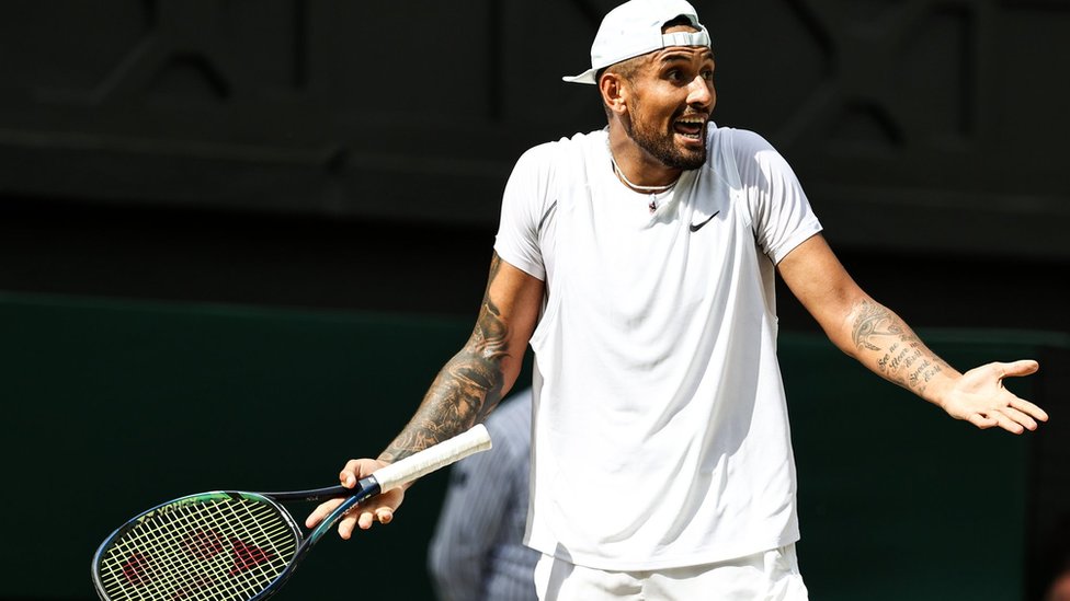 Nick Kyrgios holds his arms out in surprise