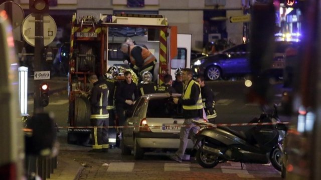 Ambulance workers are seen at the scene in the 10th arrondissement of the French capital Paris, following a string of attacks